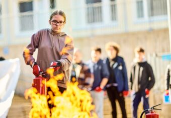 Eleven släcker en brand med en handbrandsläckare i NouHätä-övningen.