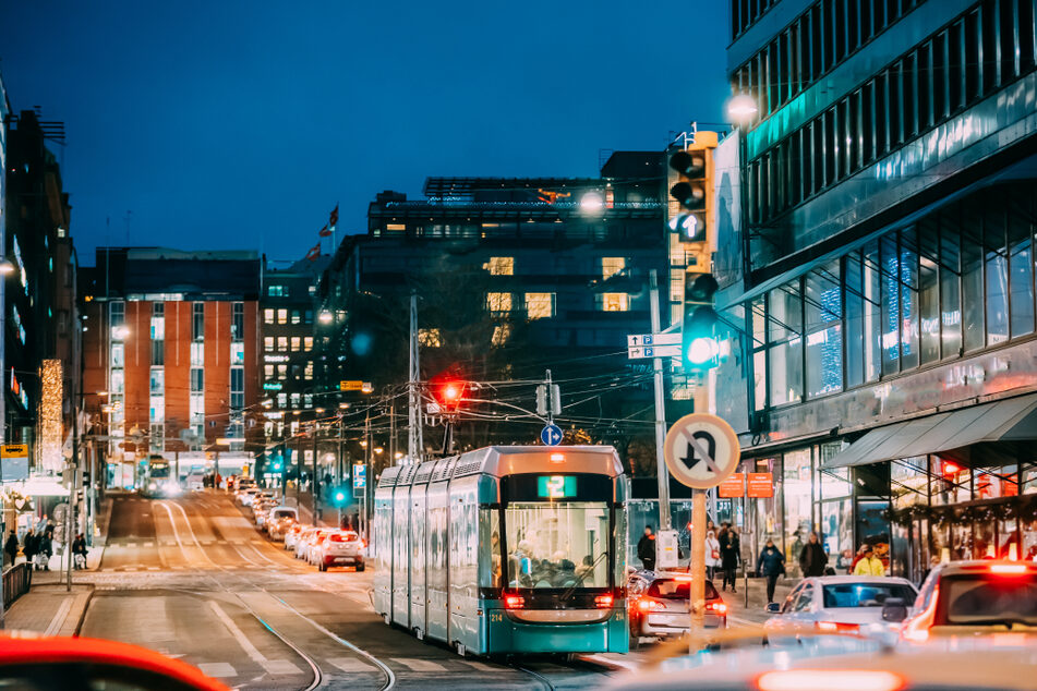 Helsinki city center at night. A tram crosses Mannerheimintie.