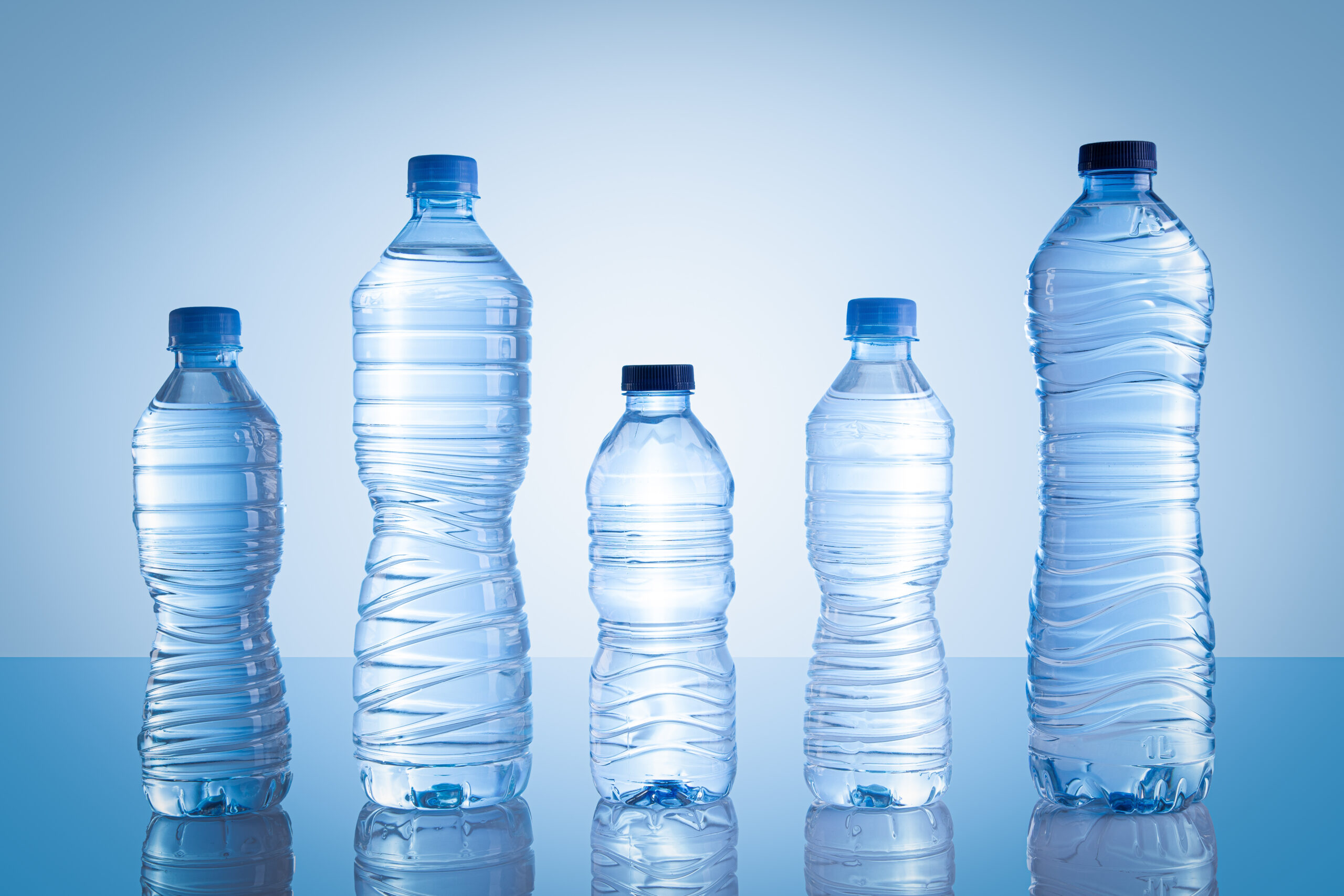Water bottles of different sizes lined up.