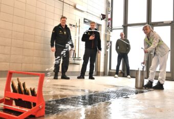 Tyttö sammuttaa sankoruiskulla kuvitteelista tulipaloa NouHätä-kilpailun rastitehtävässä.