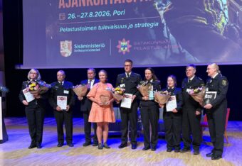 NouHätä-palkinnon saajat seisovat rivissä lavalla palkintopystit ja kukkakimput kädessä.